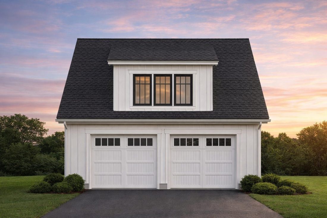 Front elevation of a Colonial Revival carriage house garage with traditional lap siding, symmetrical windows, and double garage doors
