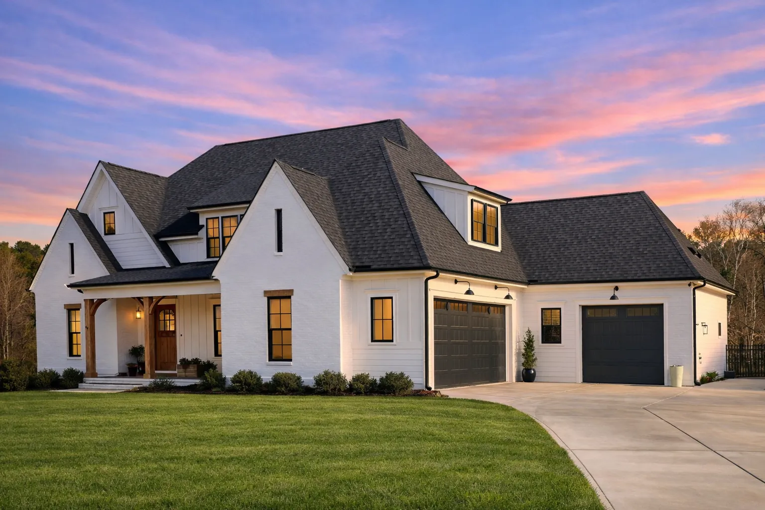 Front elevation of a modern farmhouse style home featuring white painted brick, board and batten siding, black windows, and a covered porch with wood columns
