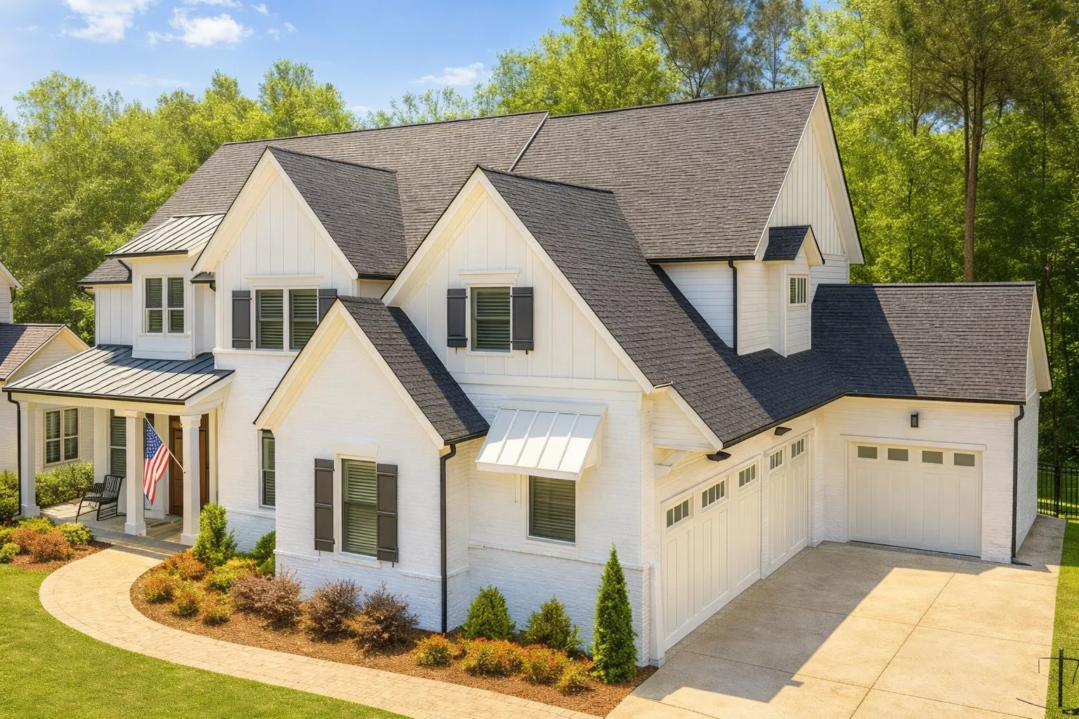 Front elevation of a New American style home featuring board-and-batten siding, painted brick exterior, gabled rooflines, and an attached garage