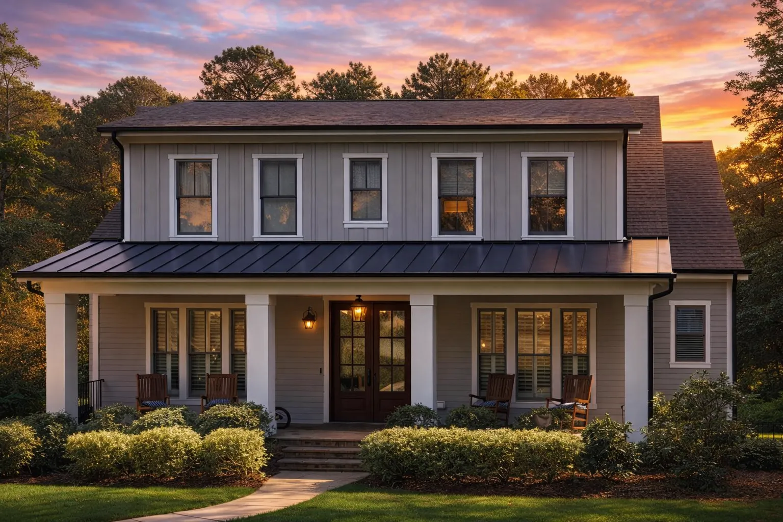 Front elevation of a Southern Colonial style home with symmetrical windows, lap siding, metal porch roof, and covered front porch