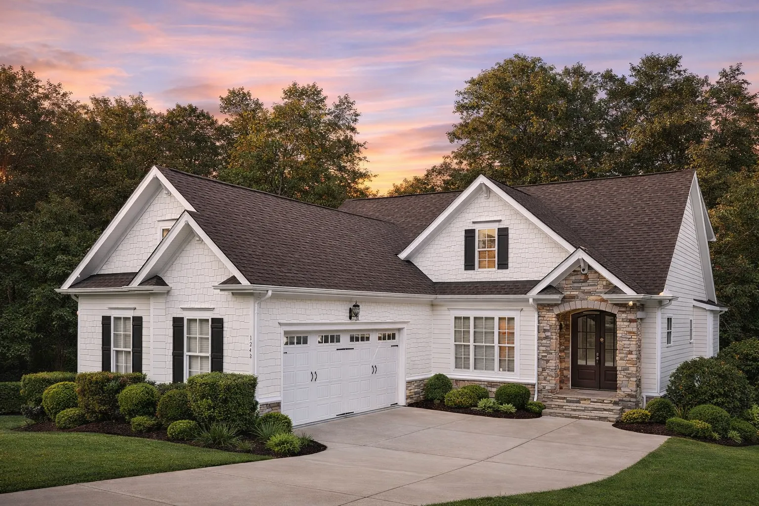 Front view of a Traditional Transitional style home featuring a mix of horizontal lap siding and stone exterior with dark shutters and a welcoming arched entryway