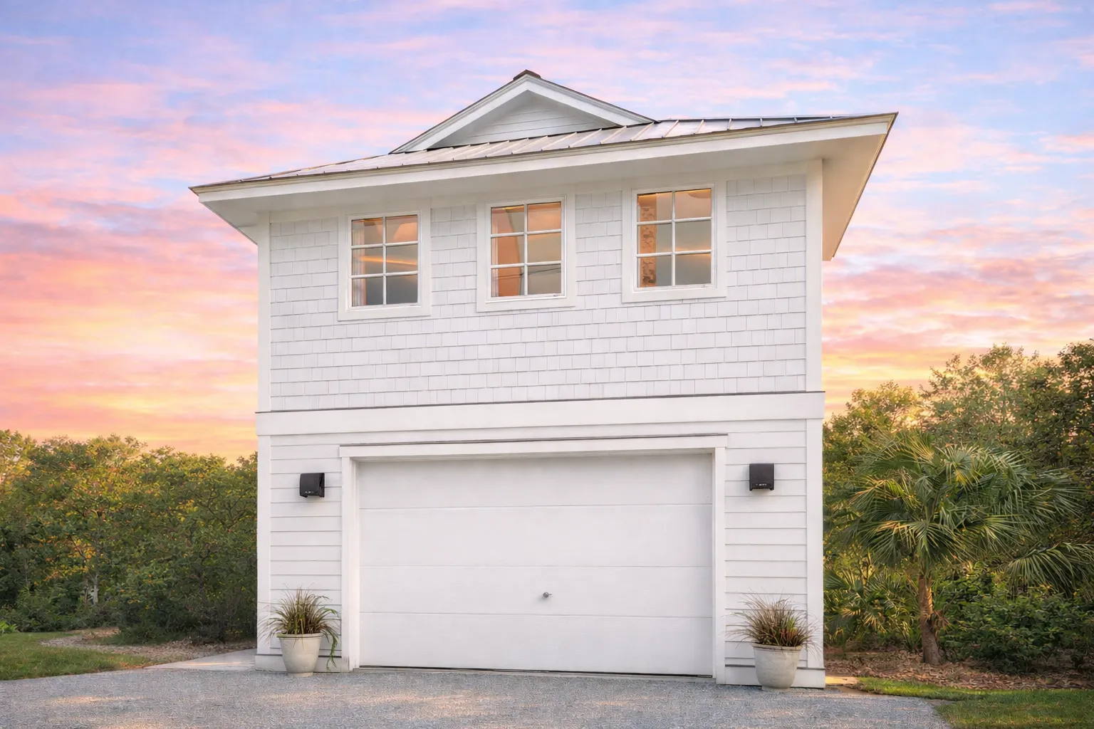 Coastal Traditional carriage house style garage apartment with horizontal siding and exterior stair access