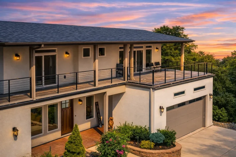 Rear elevation of a contemporary modern two-story home featuring smooth stucco exterior, large modern windows, and clean suburban architectural lines