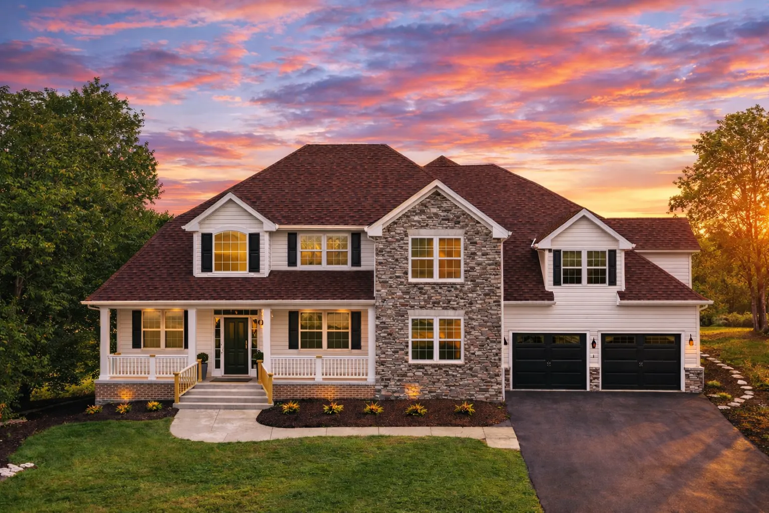 Front elevation of a Traditional Colonial style home with brick exterior, symmetrical windows, covered porch, and attached two-car garage