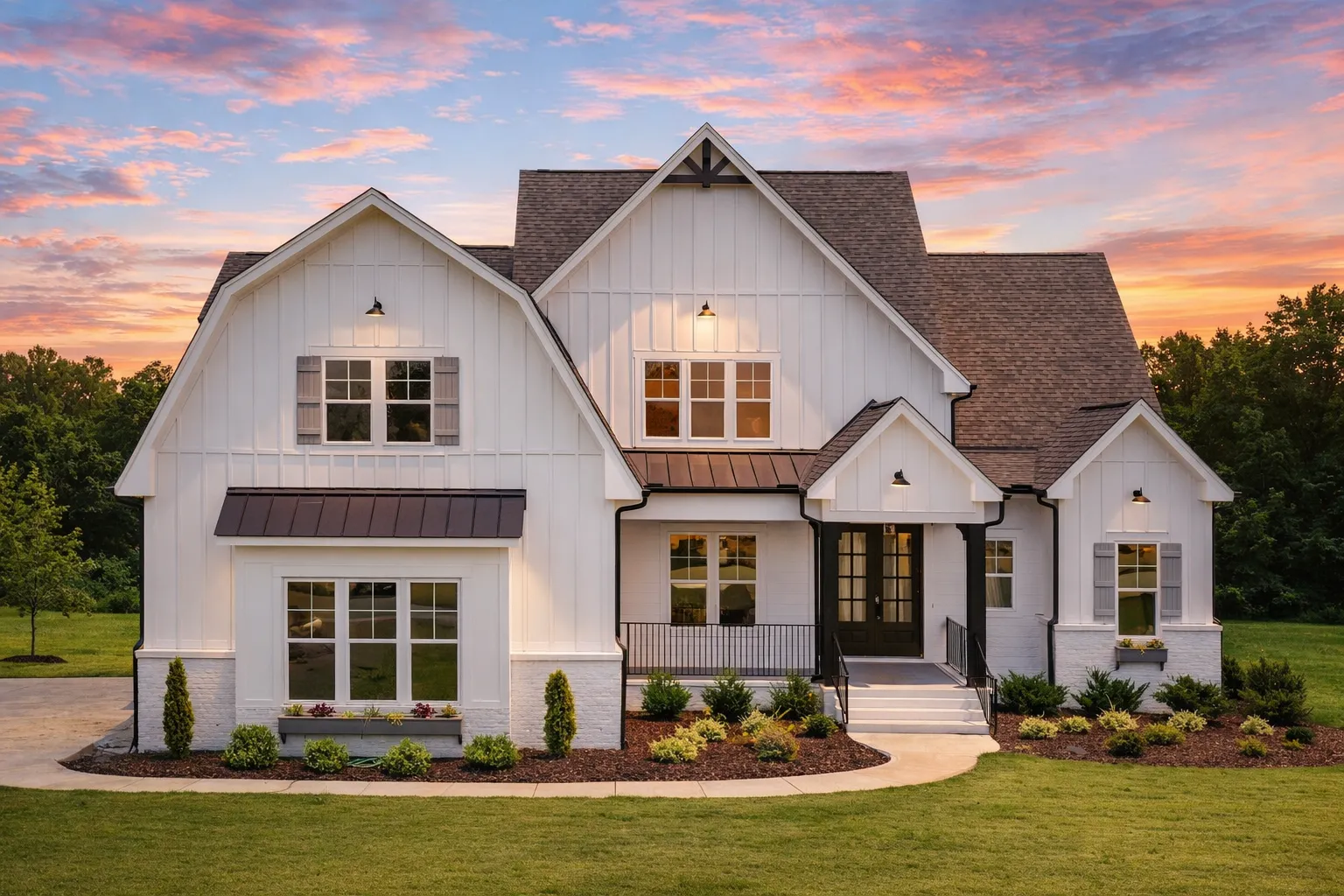 Front elevation of a modern farmhouse style home featuring board and batten siding, stone accents, steep gables, and a welcoming covered entry