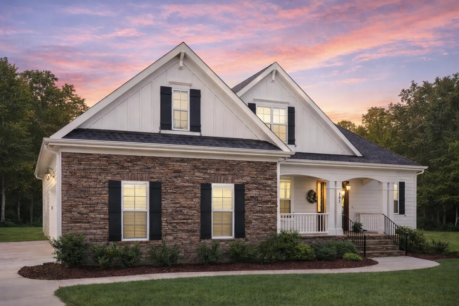 Front elevation of a New American Modern Traditional house featuring stone veneer, horizontal siding, board and batten gables, and a welcoming covered porch