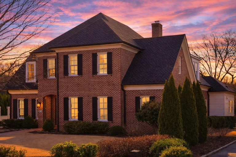 French Country Farmhouse Plans 1 Front elevation of a Traditional Colonial style brick home with symmetrical windows, black shutters, and a centered entry