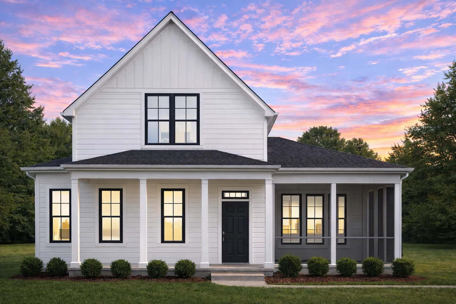Front elevation of a Modern Farmhouse style home featuring board and batten siding, stone accents, black windows, and a covered front porch