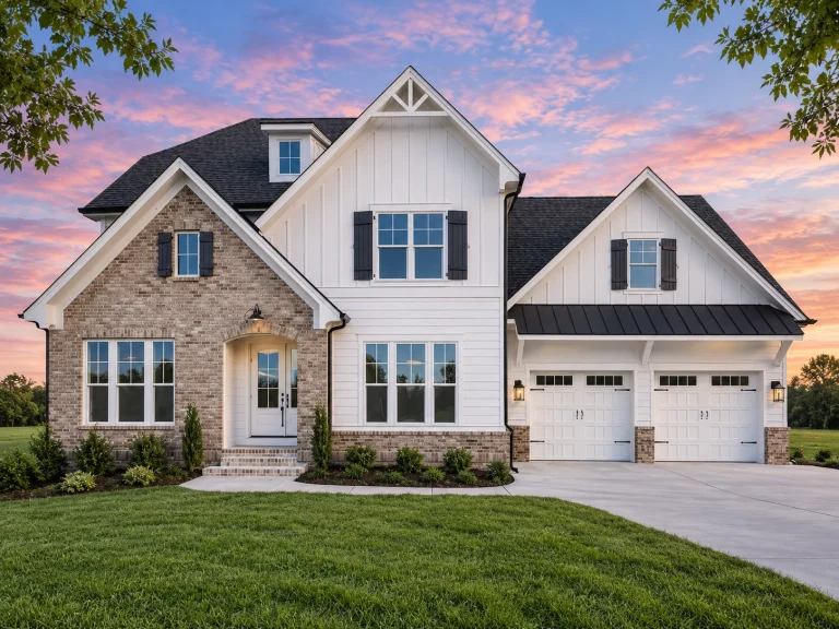 Front exterior of a Modern Farmhouse style home featuring board and batten siding, stone accents, gabled rooflines, and an attached garage