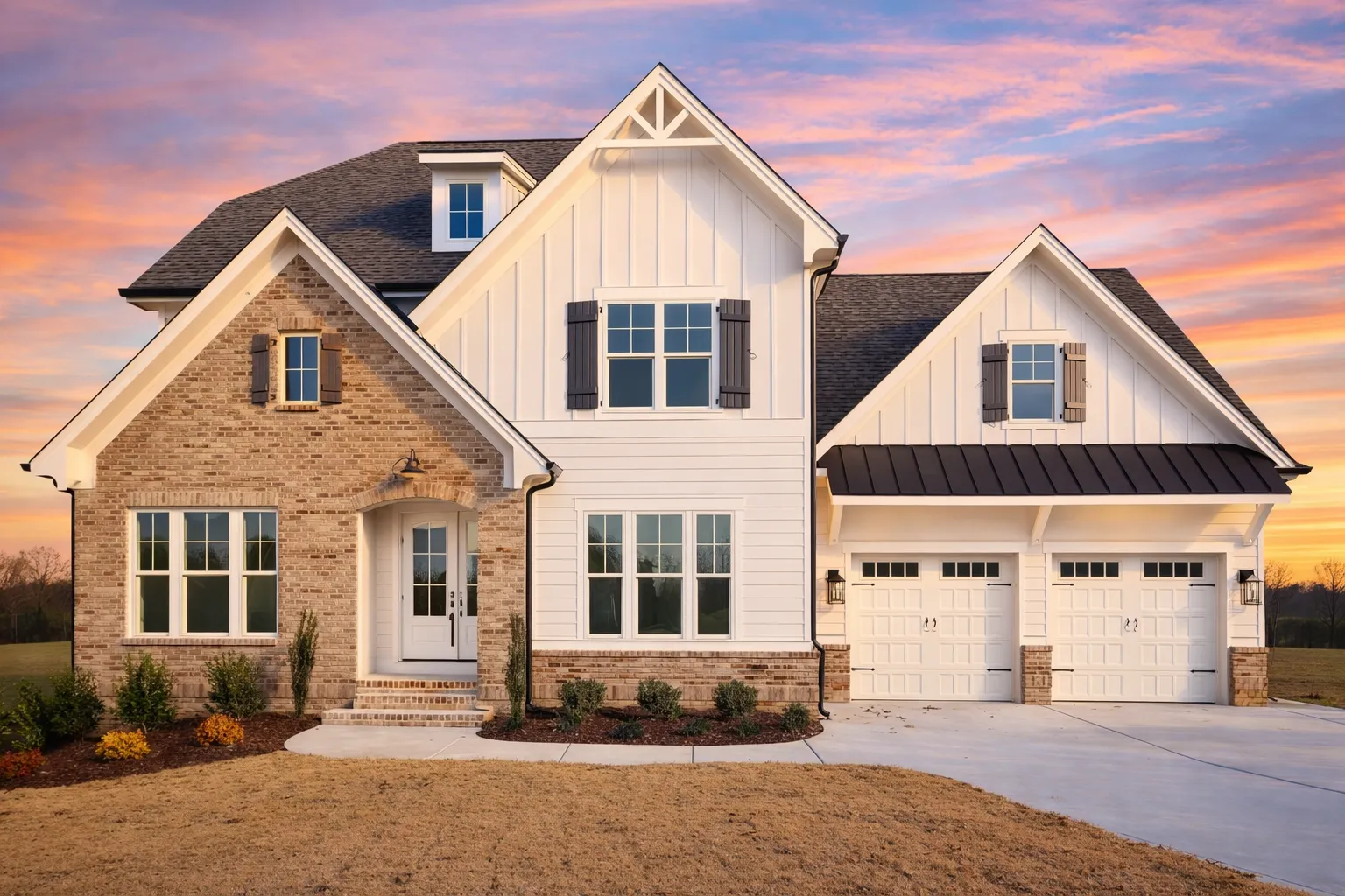 Front exterior of a Modern Farmhouse style home featuring board and batten siding, stone accents, gabled rooflines, and an attached garage