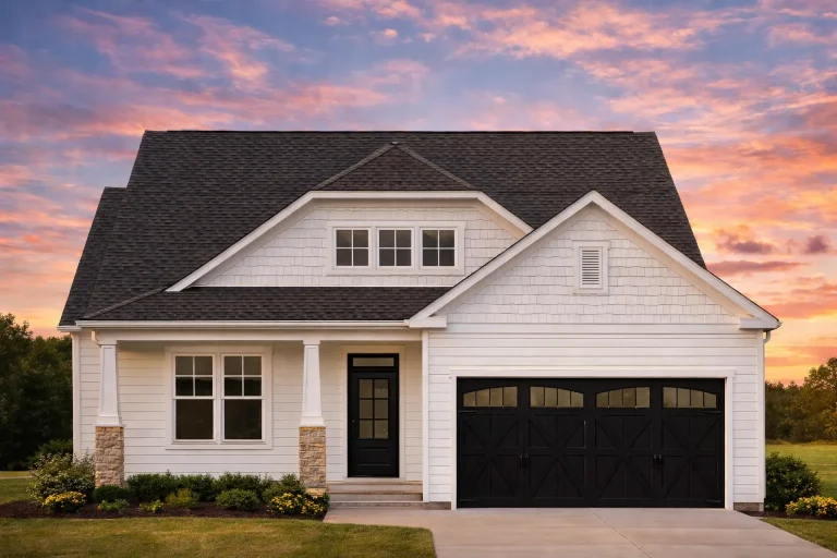 Front view of a Craftsman Cottage style home featuring warm siding, stone column bases, and a welcoming covered porch entry