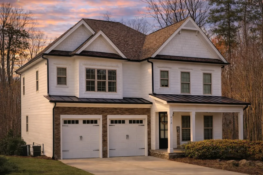 Front exterior of New American Modern Traditional house with horizontal lap siding, gabled rooflines, double garage, and covered front porch