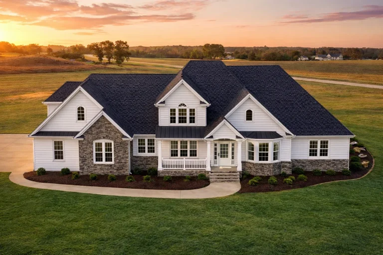 Front elevation of modern farmhouse style home with painted brick exterior, board and batten gables, black roof, and expansive covered porch