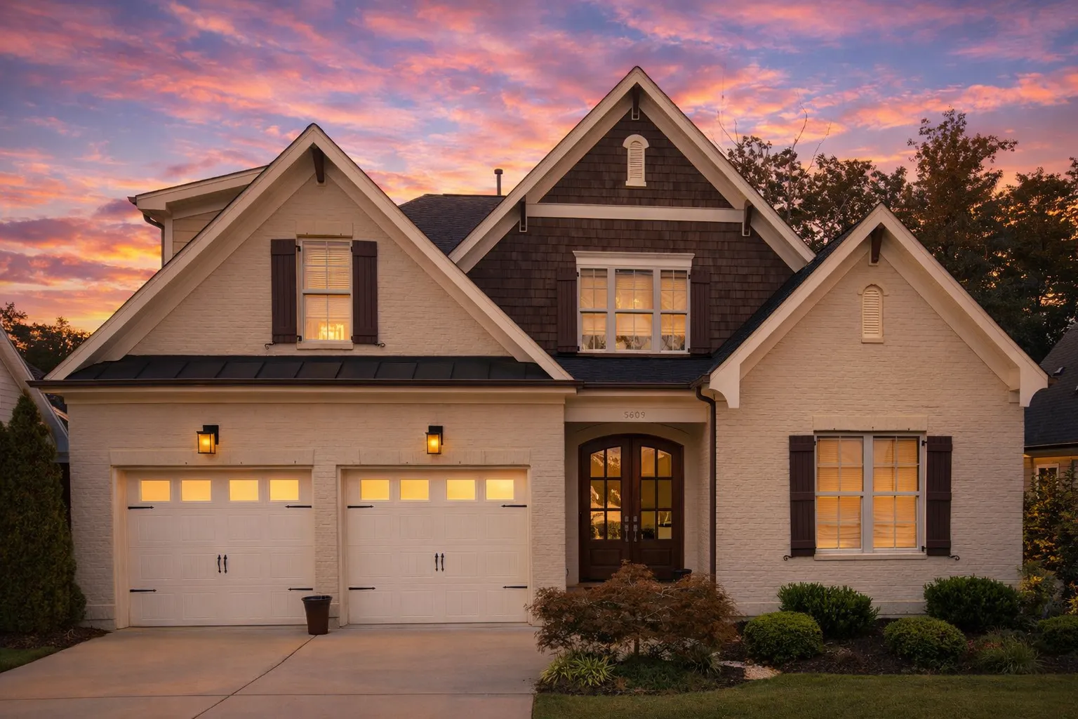 Craftsman House Plans 17 Front elevation of a New American style home with brick and siding exterior, wood shutters, steep gable roof, and double garage
