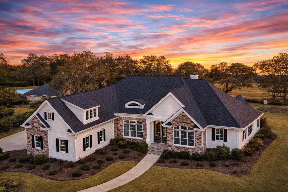 Front elevation of a New American traditional house with brick exterior, symmetrical windows, steep gabled roof, and classic Colonial Revival detailing