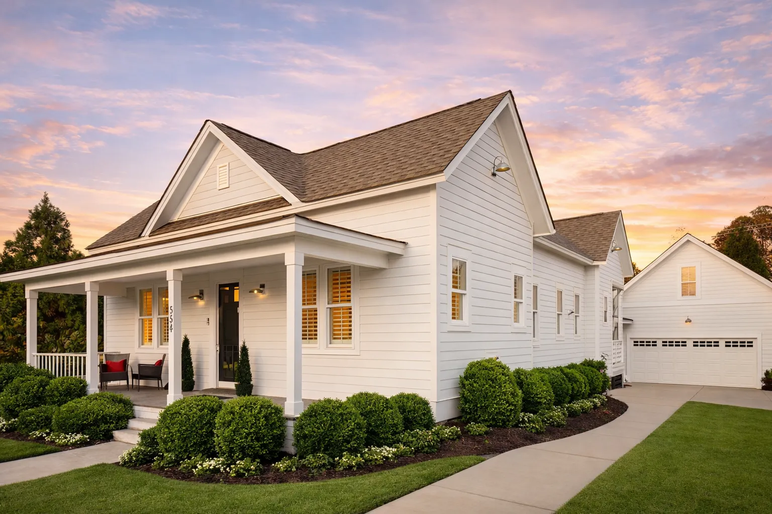 Modern House Plans 11 Front elevation of an American Cottage style house featuring Colonial Revival influences, horizontal siding, black shutters, and a welcoming covered porch
