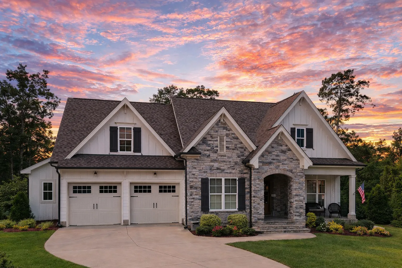 Front elevation of a New American modern traditional house with stone veneer, horizontal siding, gabled rooflines, and attached garage