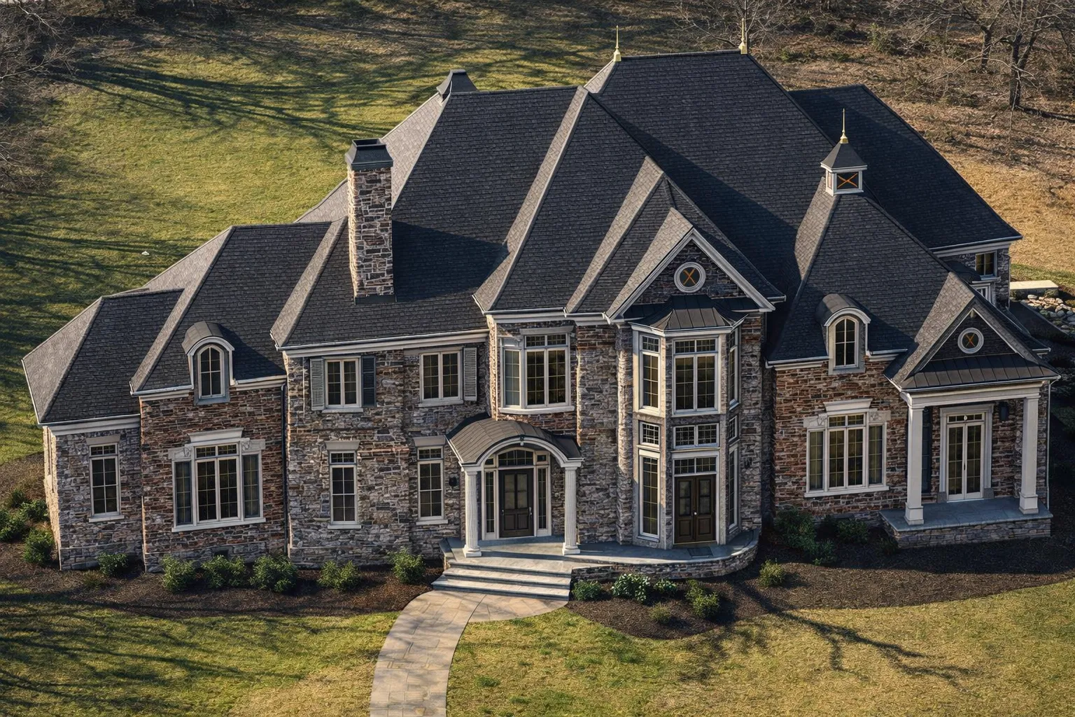 Front elevation of a Georgian Neo-Georgian style luxury home with brick exterior, stone detailing, tall central windows, and symmetrical classical architecture