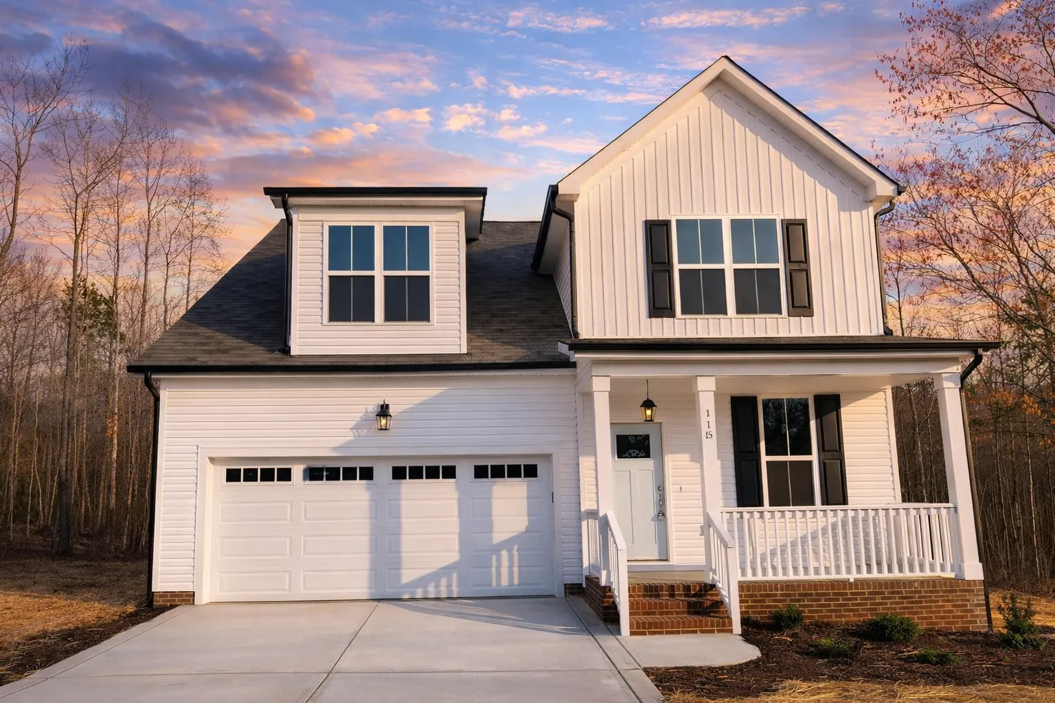 Front elevation of a Modern Farmhouse style home featuring board and batten siding, brick accents, black-framed windows, and a welcoming covered porch