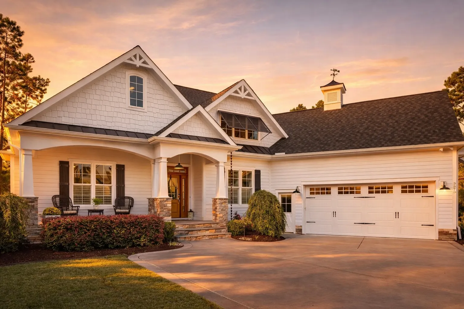 Front exterior of a New American Traditional Suburban style home with horizontal lap siding, board-and-batten accents, covered front porch, and side-entry garage