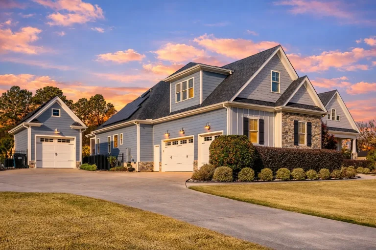 Front elevation of a Traditional Craftsman style home with lap siding, shingle gables, stone base, and covered front porch