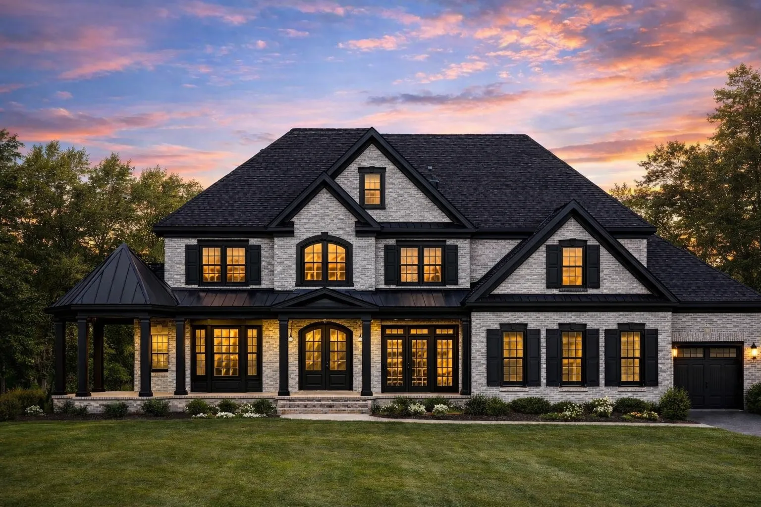 Front elevation of a Traditional Colonial home with horizontal lap siding, shingle-accented gables, symmetrical windows, and a wide covered front porch
