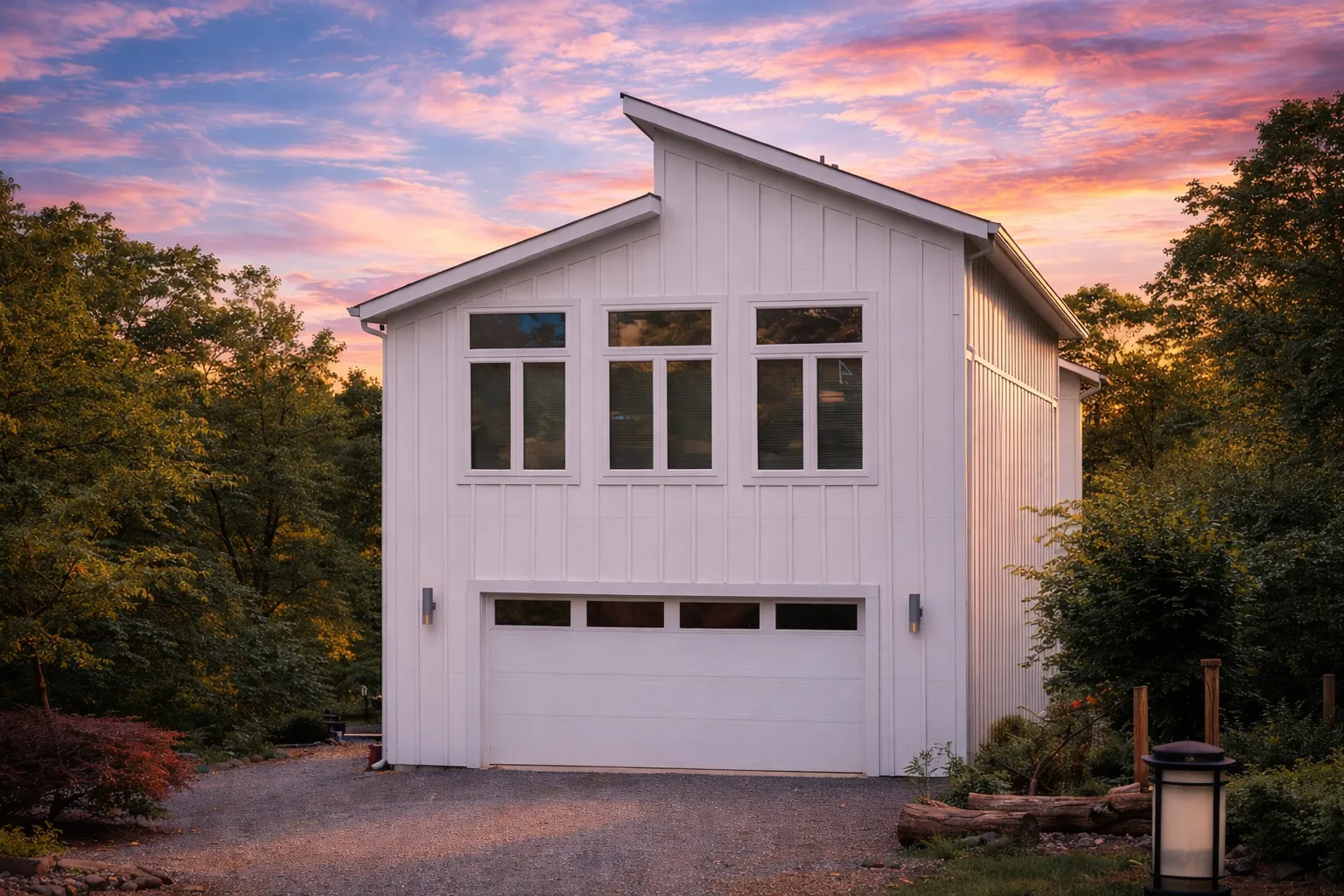 Front elevation of a modern farmhouse carriage house garage apartment featuring vertical board and batten siding and symmetrical window design
