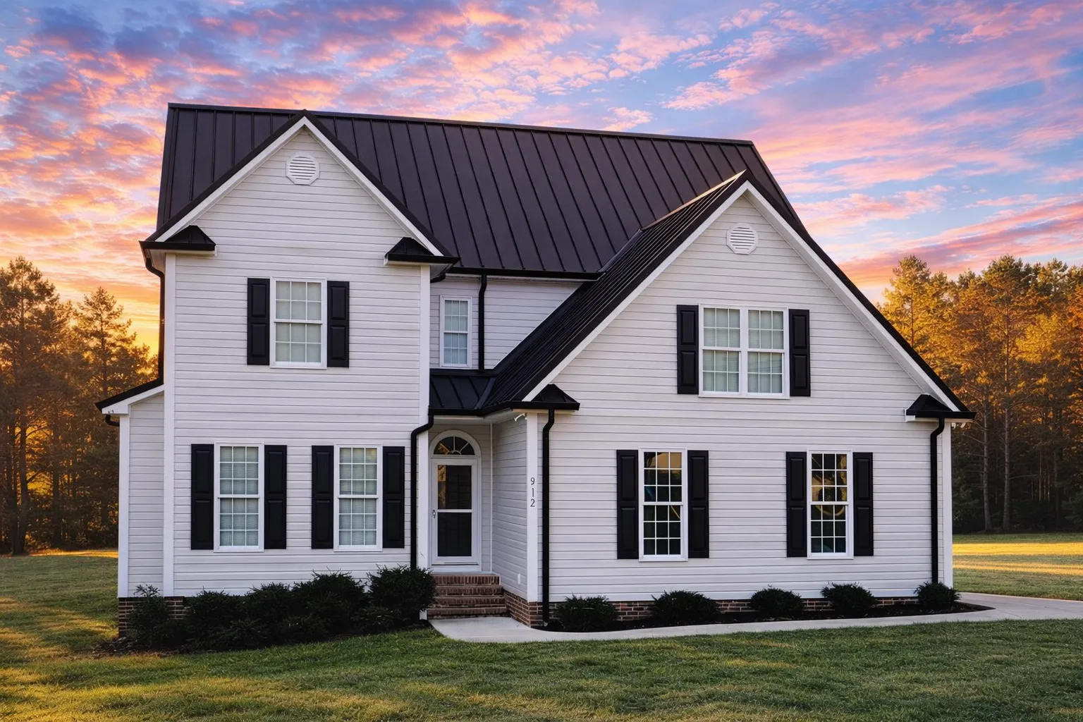 Front elevation of a Traditional Colonial home with New American design influence featuring a mix of horizontal siding and shingle accents, symmetrical windows, and gabled rooflines.