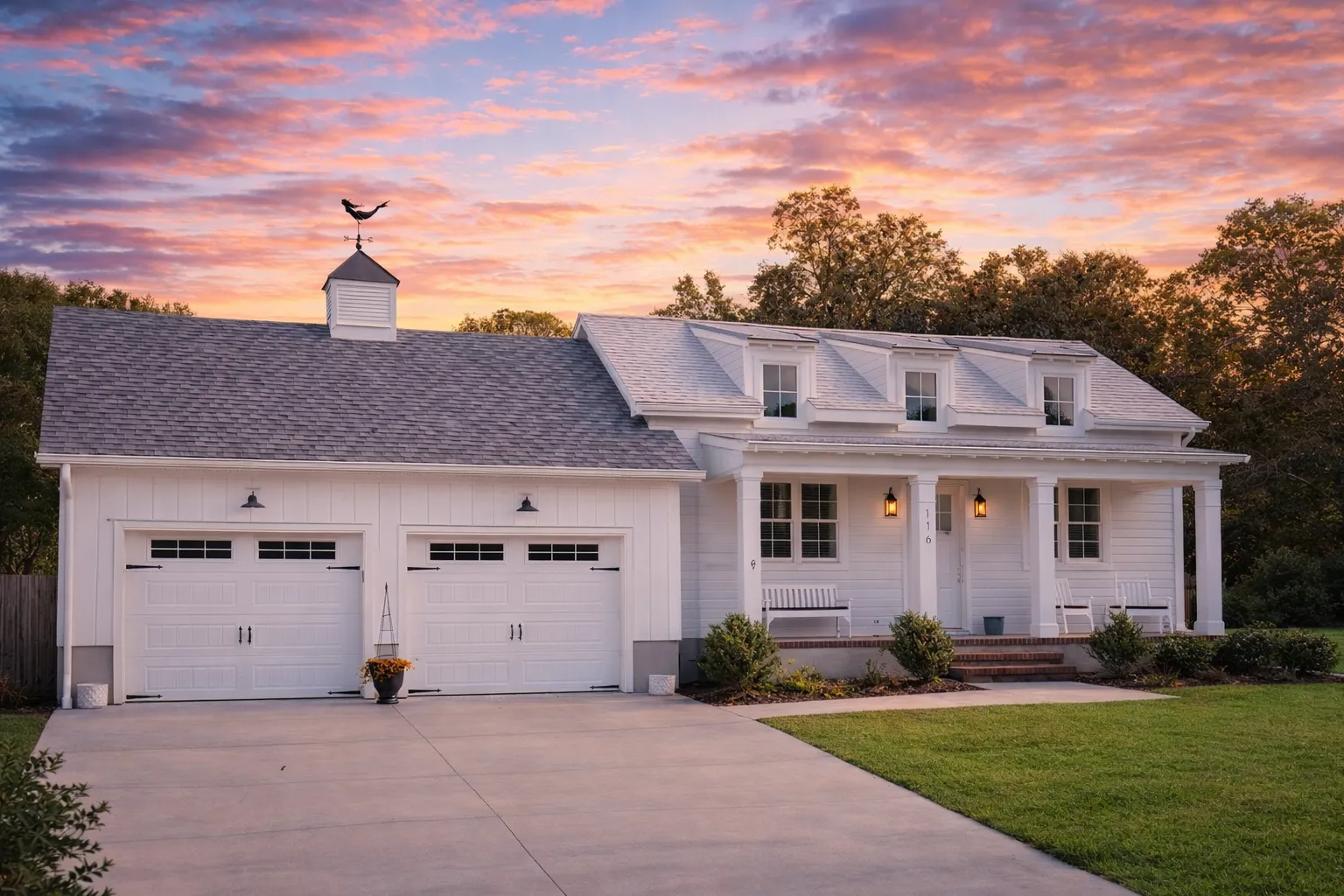 Front elevation of Cape Cod coastal traditional home with clapboard siding, dormer windows, covered porch, and attached garage