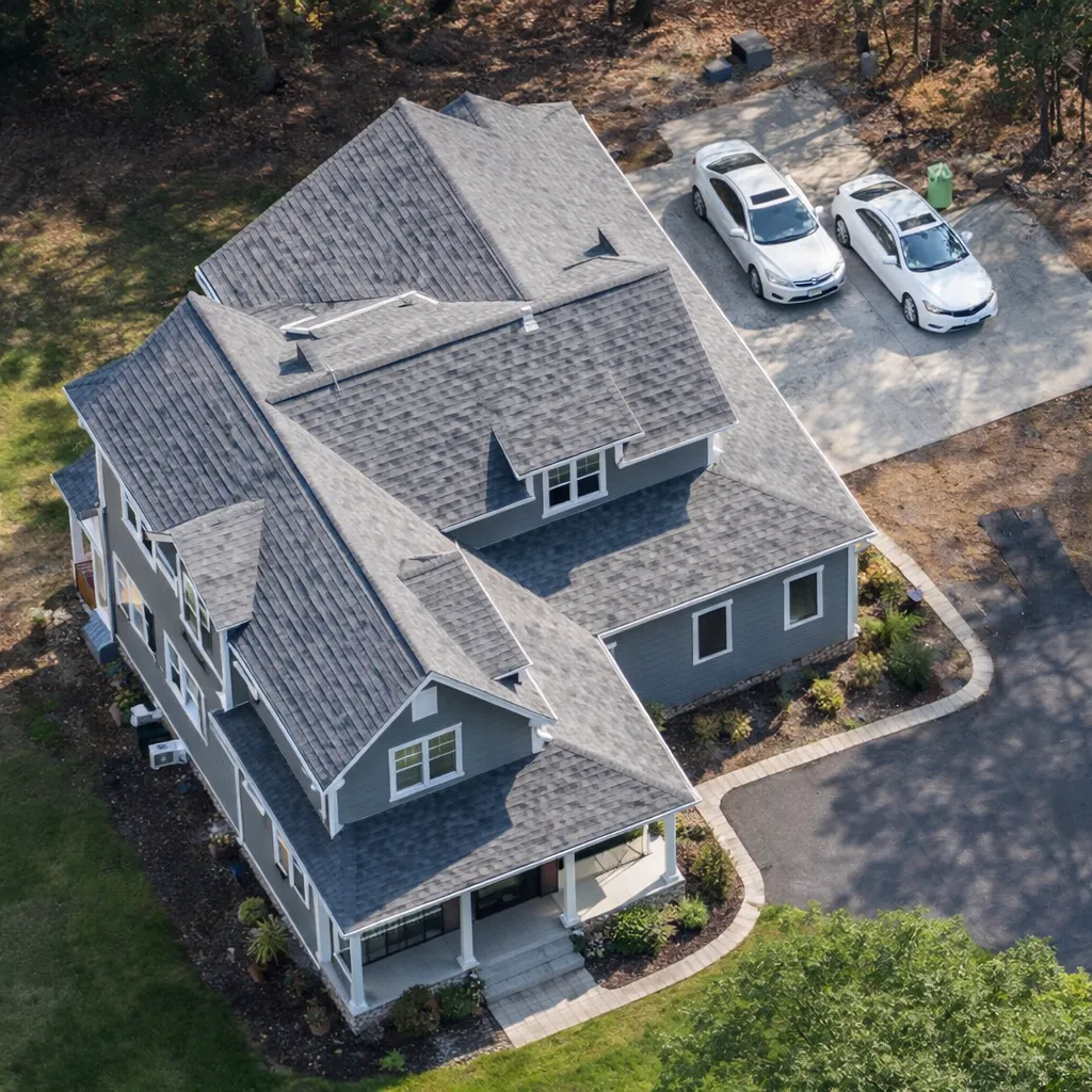 Front view of a Modern Farmhouse Cottage style home with board and batten siding, shingle gable accent, and inviting front porch entry