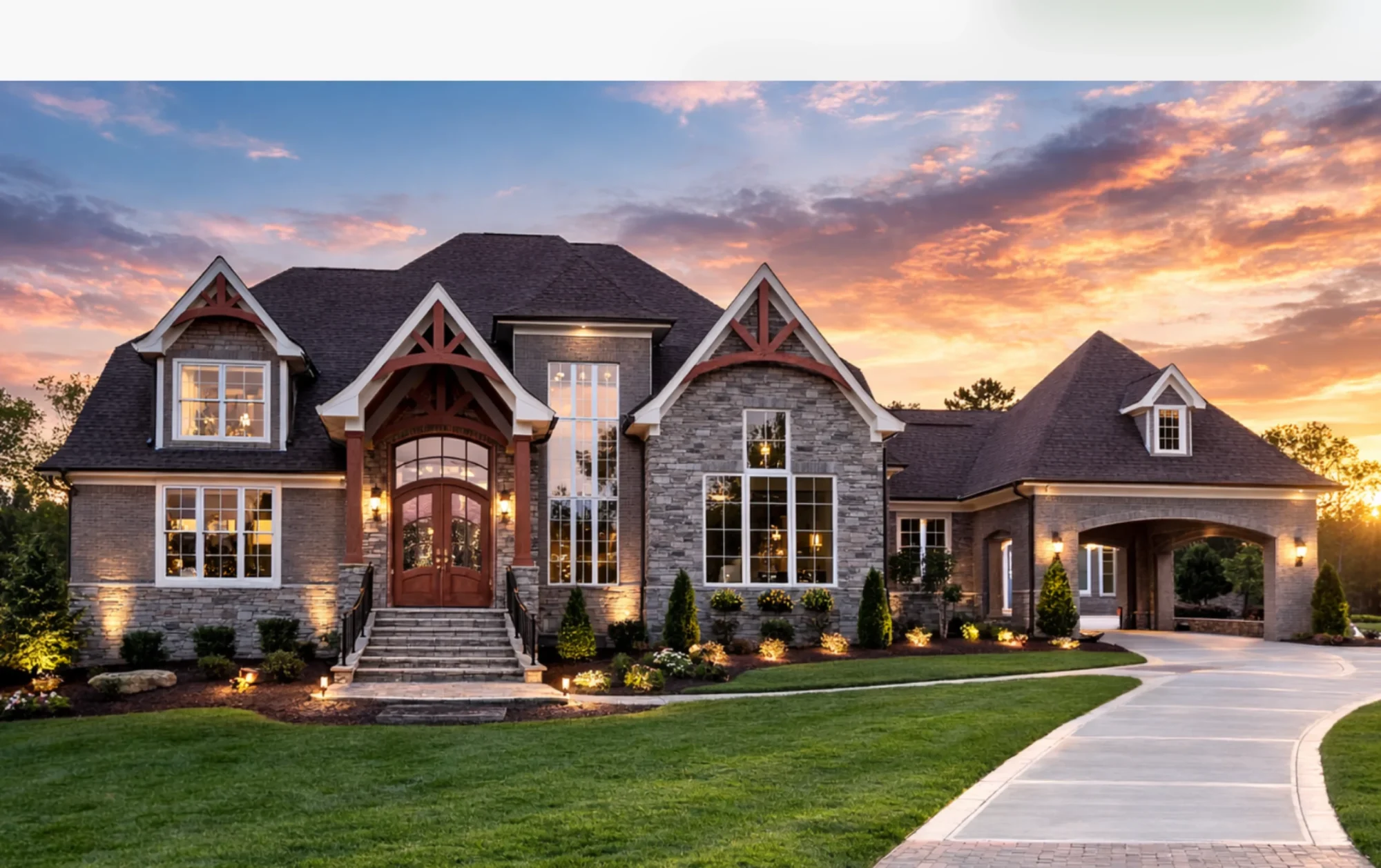 Front elevation of a Tudor Revival style luxury home with brick and stone exterior, steep gabled rooflines, and decorative timber accents