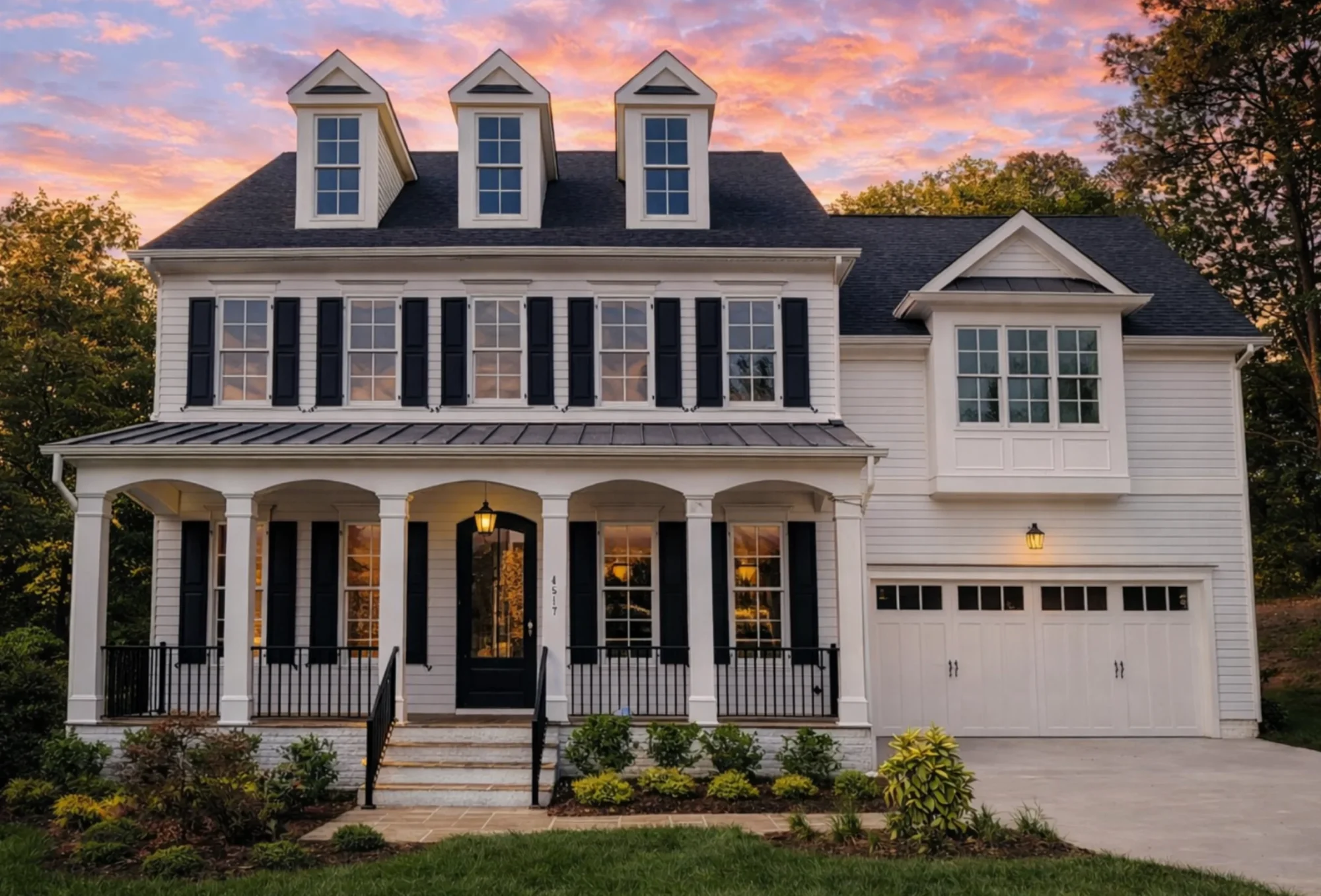 Front elevation of a Traditional Colonial style brick home with symmetrical windows, dormer accents, and an arched central entry