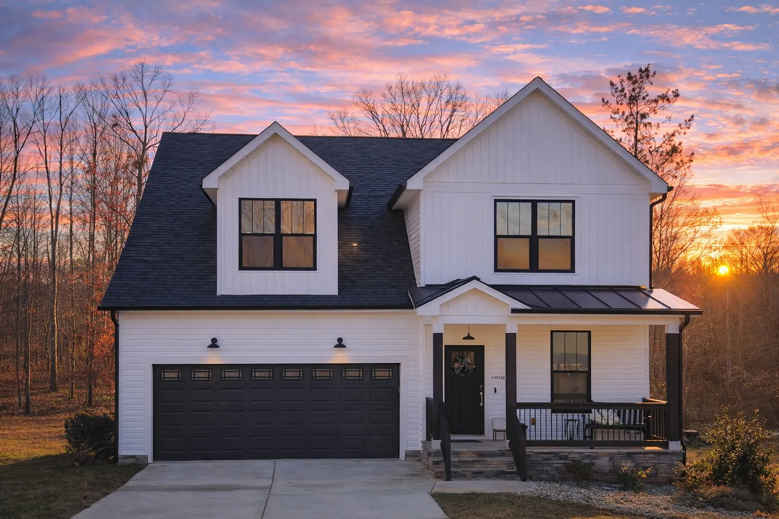 Front view of a Traditional Ranch Cottage home featuring horizontal siding, brick foundation, and a welcoming covered porch with classic columns