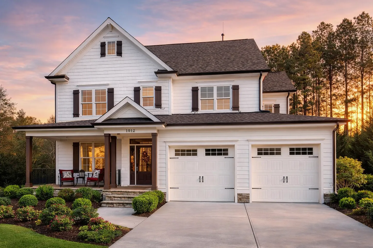 Front elevation of a New American modern traditional house with horizontal siding, stone accents, black shutters, and a three-car garage