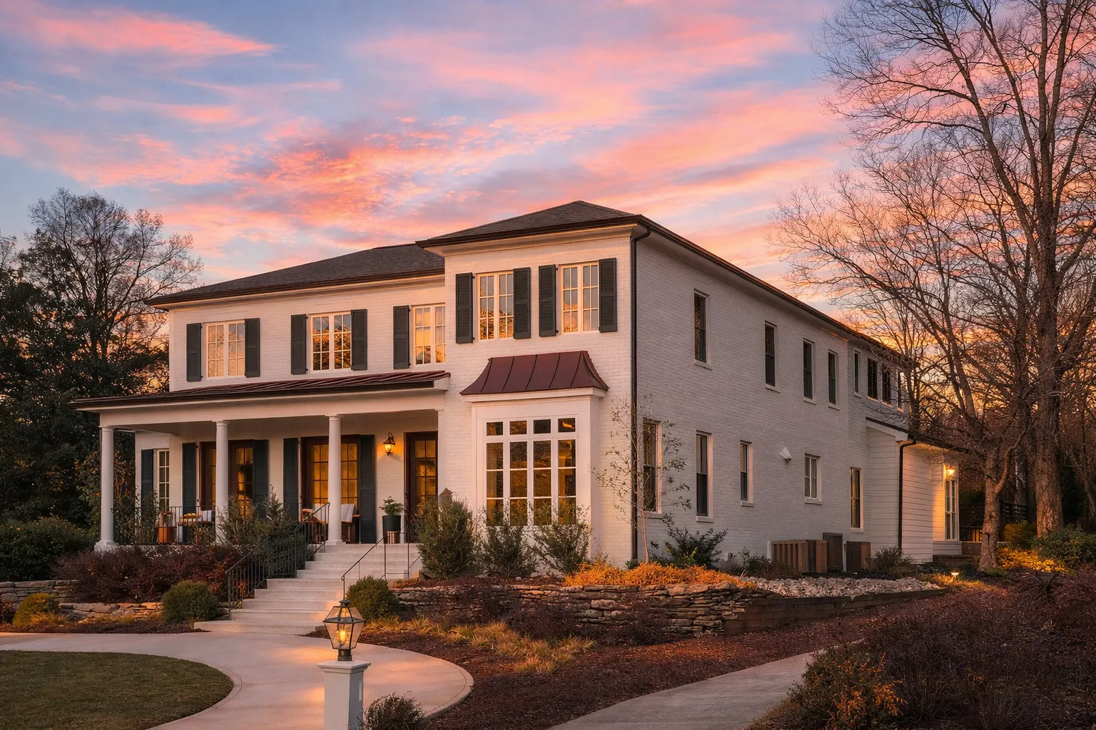 Front elevation of a Traditional Colonial style home featuring painted clapboard siding, symmetrical windows, and a classic covered front porch