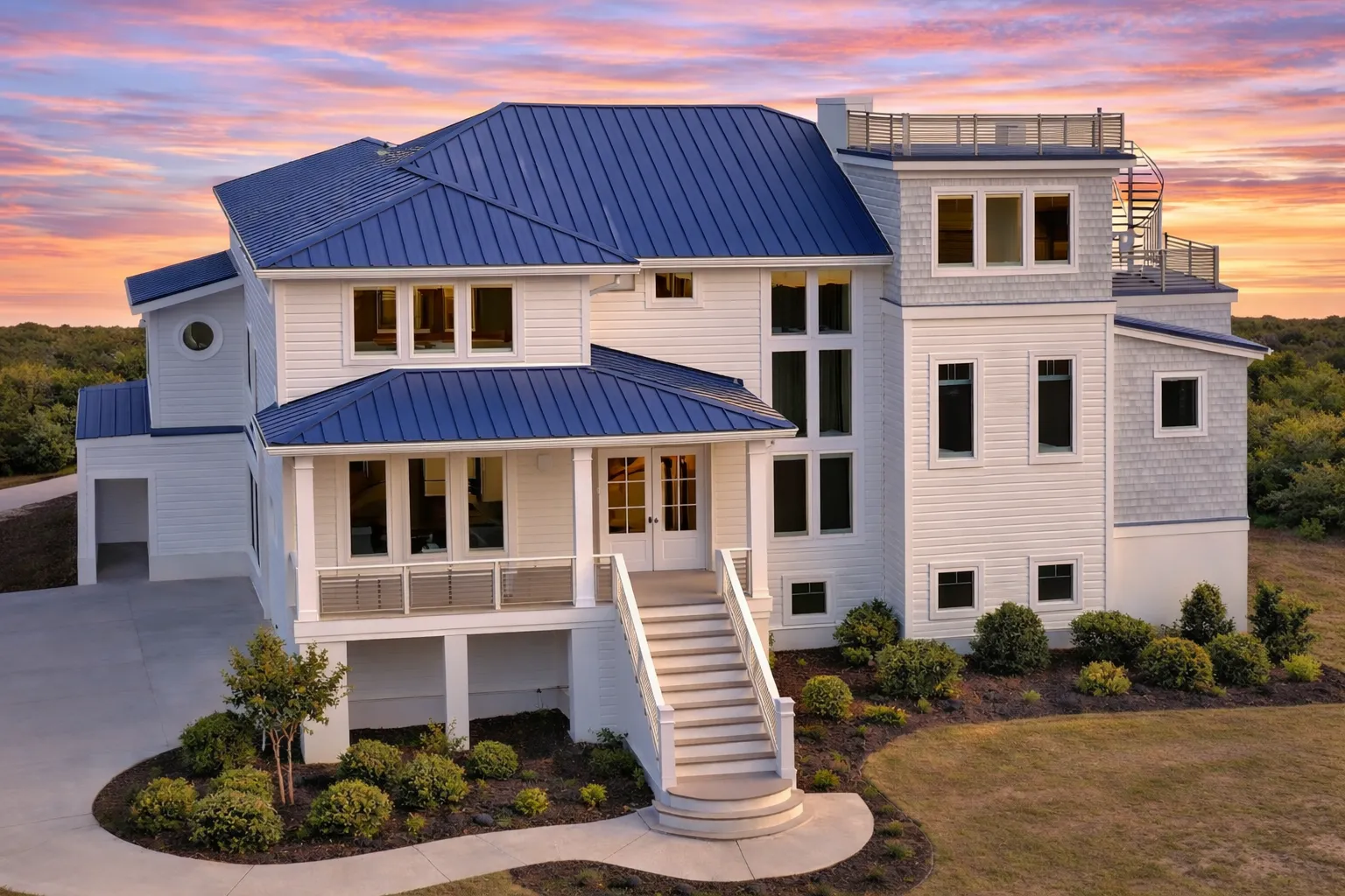 Front exterior view of a Coastal Contemporary home with horizontal siding, elevated entry, large windows, and modern coastal architecture