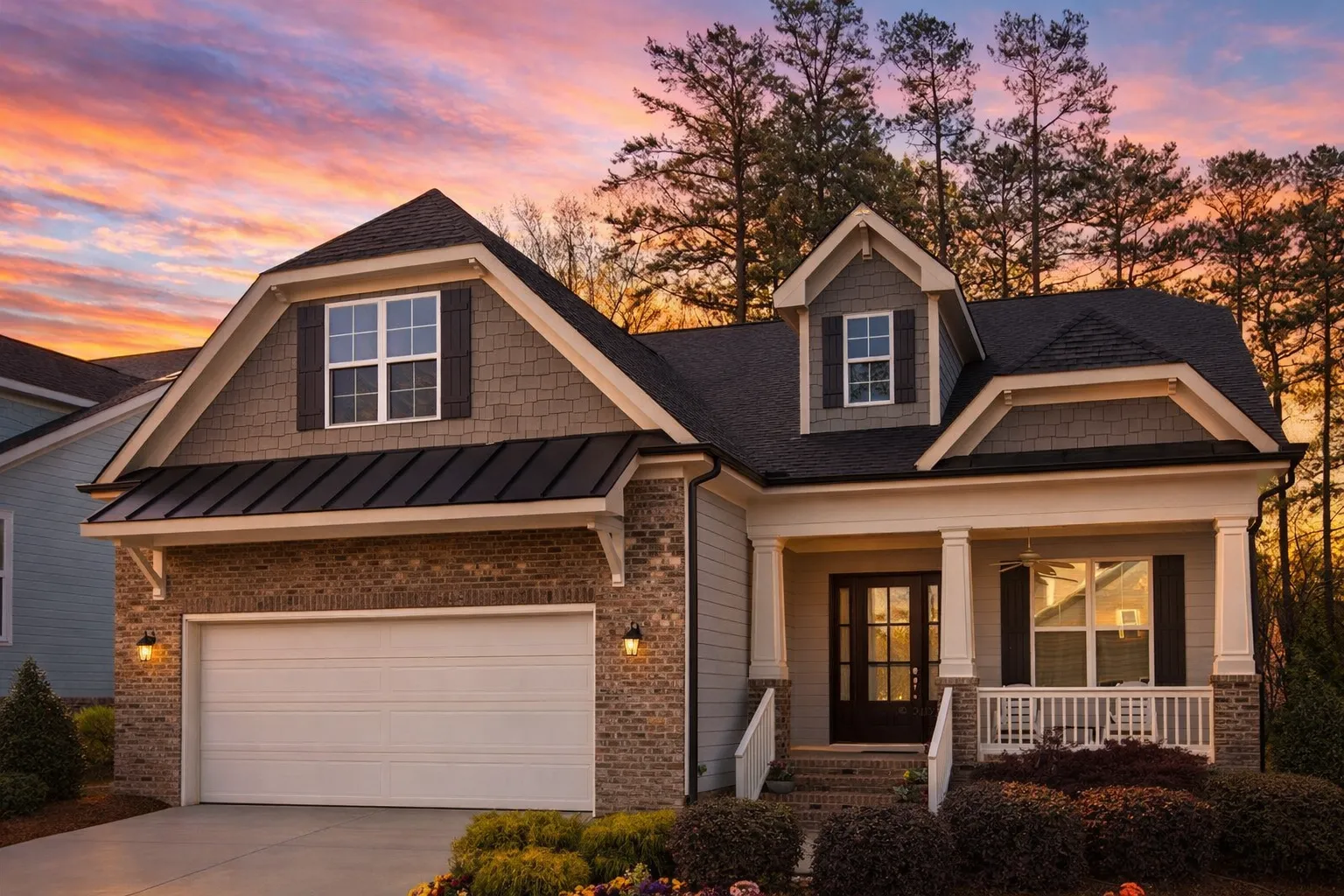 Front elevation of Craftsman Traditional Suburban house with brick exterior, horizontal lap siding, shake gables, and covered porch