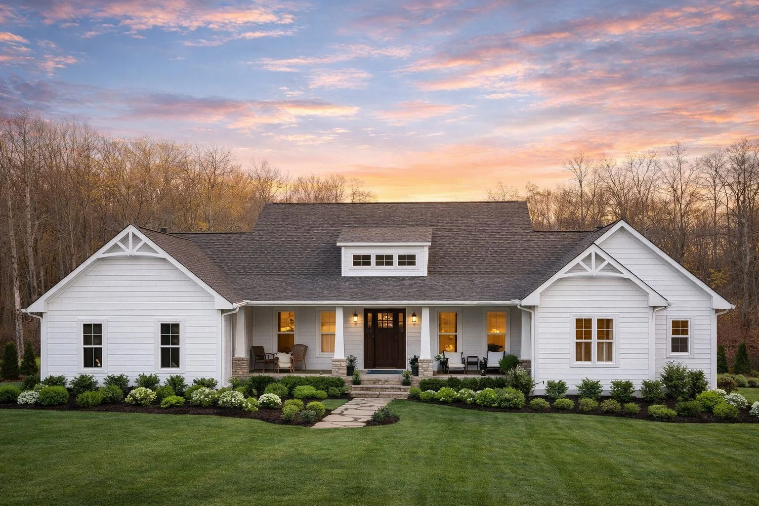 Front exterior view of a Cape Cod style home with horizontal siding, gabled roof, symmetrical windows, and a welcoming covered porch