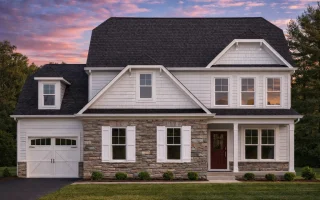 Front elevation of a Traditional Colonial style house featuring stone and horizontal siding, wood shutters, and symmetrical windows for classic curb appeal