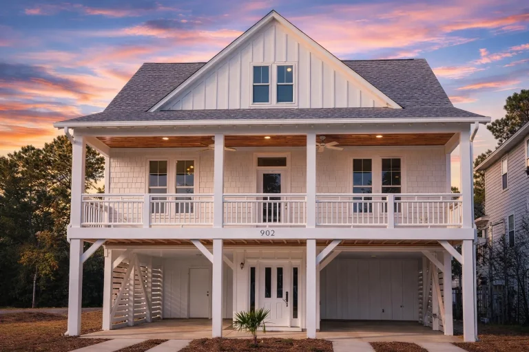 Front elevation of a Modern Farmhouse coastal-style home featuring board and batten siding, shingle accents, metal roof, and a full-width porch