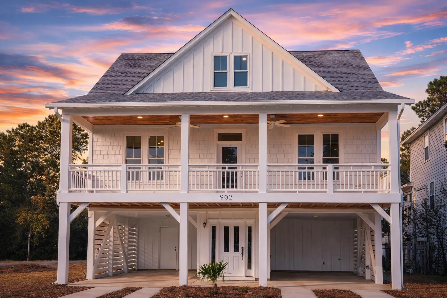 House Plans with Rear Entry Garage 15 Front elevation of a Modern Farmhouse coastal-style home featuring board and batten siding, shingle accents, metal roof, and a full-width porch