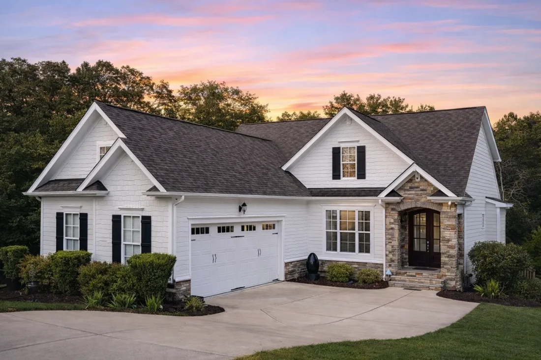 Front elevation of a New American style home featuring brick exterior, board and batten siding, and symmetrical modern traditional design