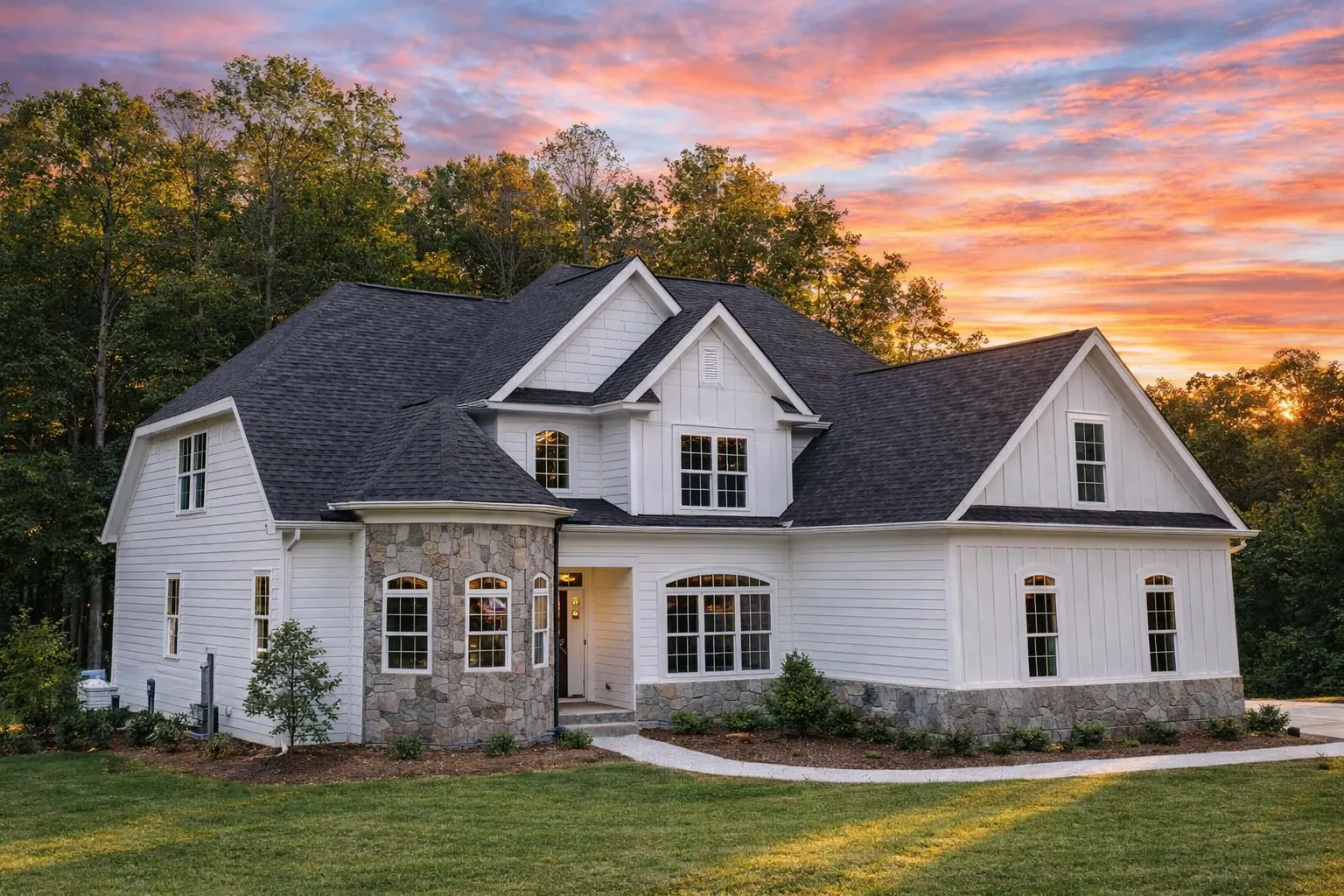 Front view of a Traditional Colonial home with horizontal siding, stone accents, gabled rooflines, and symmetrical windows for classic curb appeal