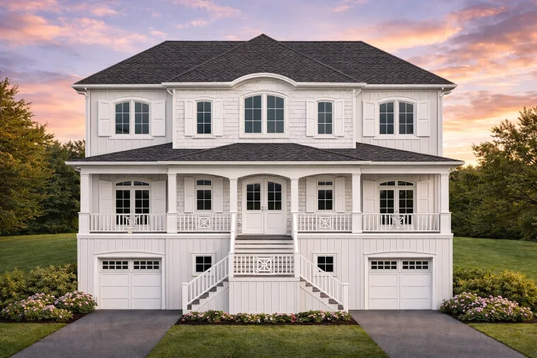 Front elevation of Coastal Traditional Low Country style home with white lap siding, double stacked porches, and dual garage bays