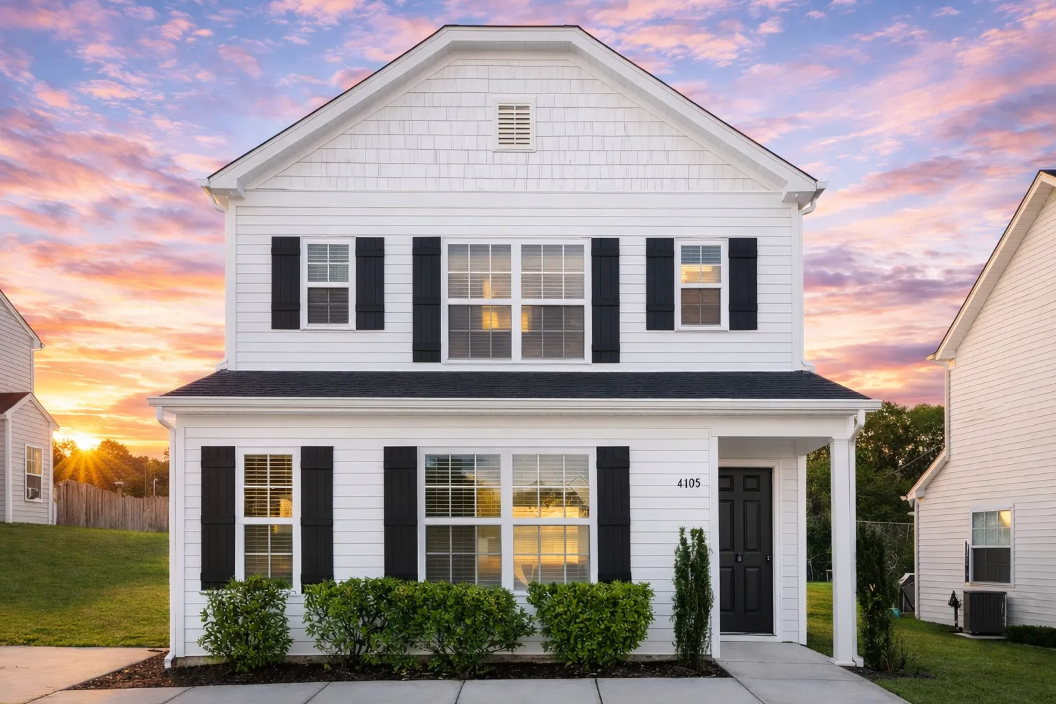 RV Garage Plans 7 Front elevation of a Colonial style two-story house featuring horizontal lap siding, black shutters, and a traditional covered entry porch with columns.
