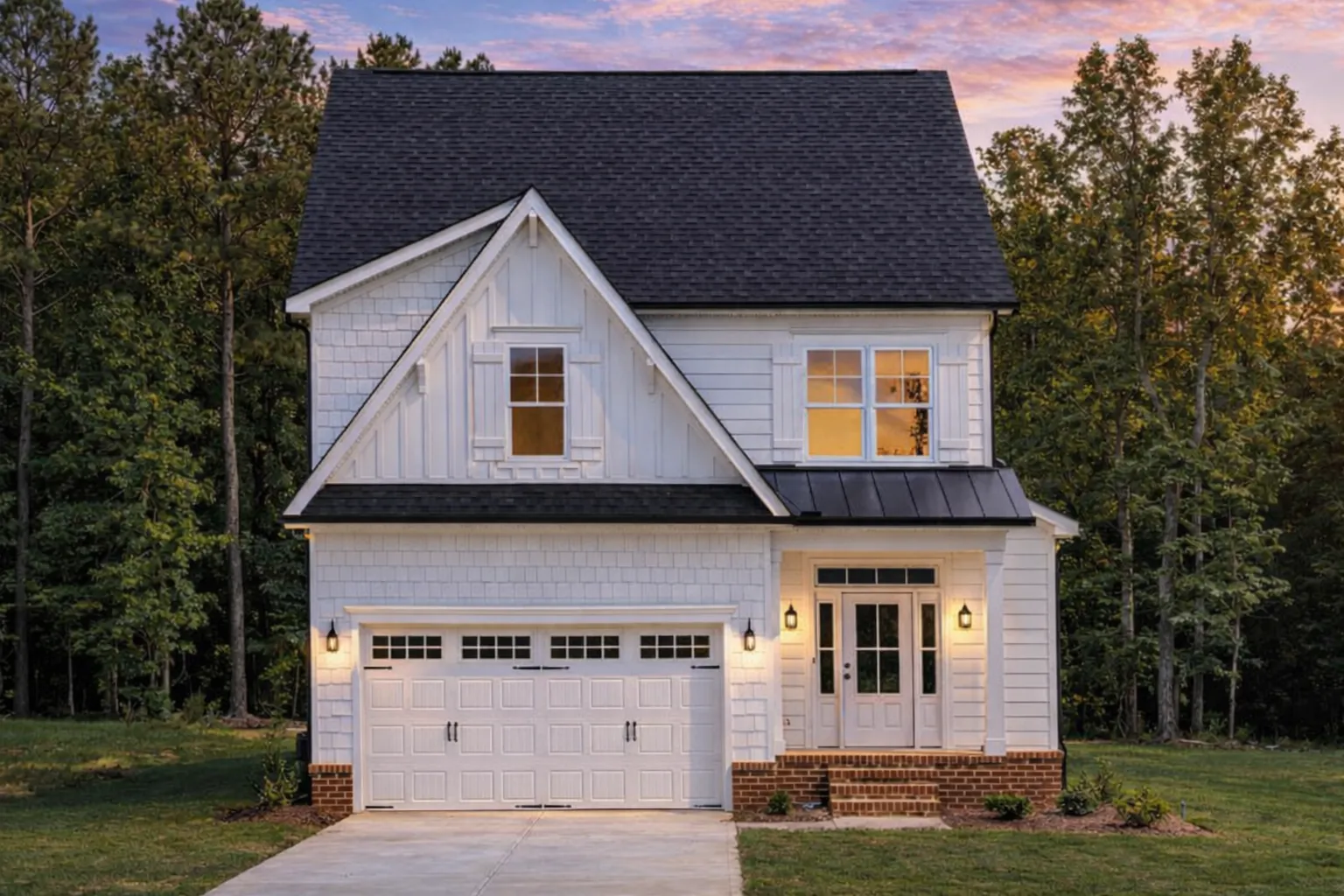 Front view of a Modern Farmhouse style home featuring board and batten siding, dark trim accents, and a welcoming covered entry porch