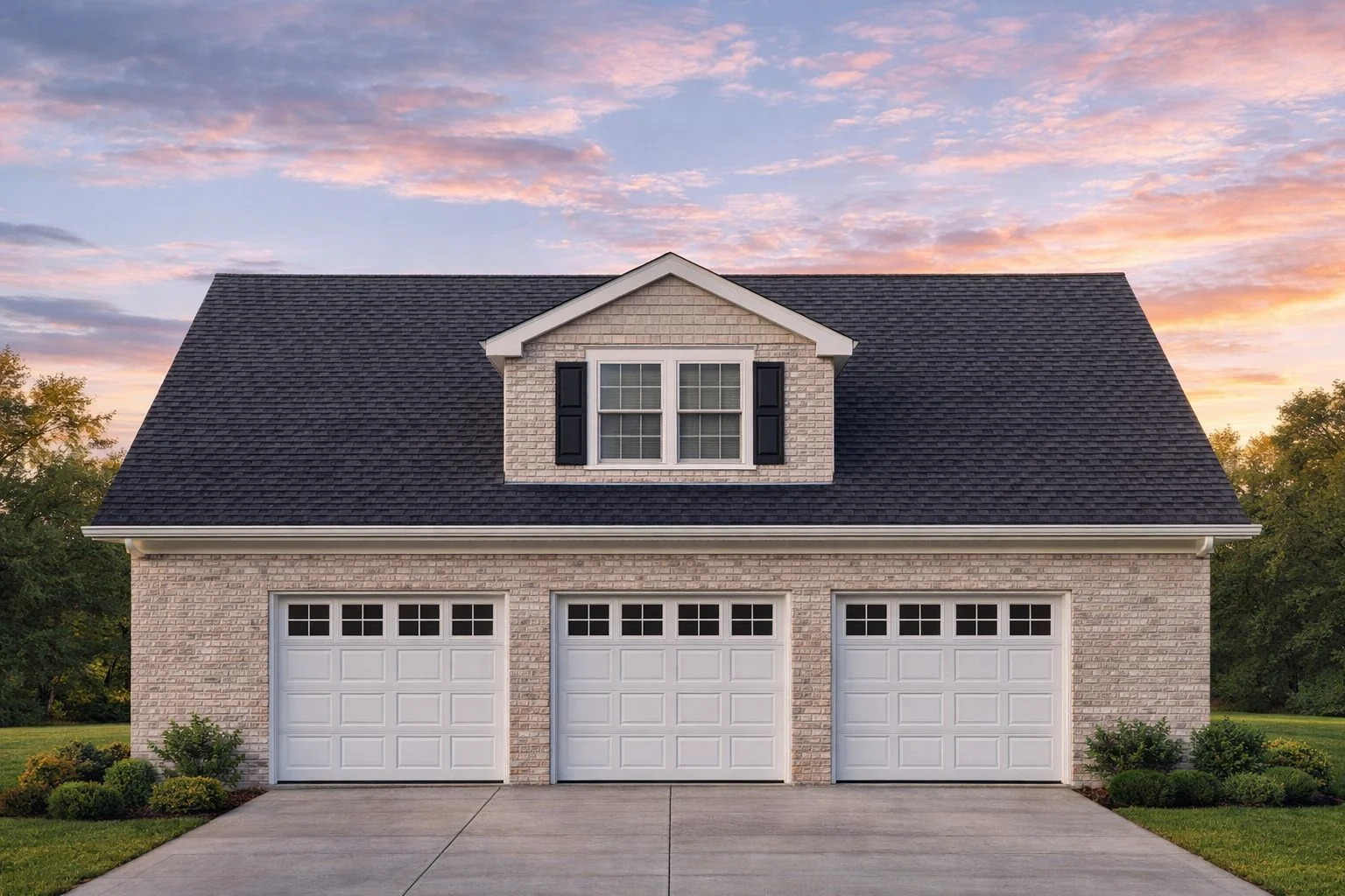 Traditional Colonial style carriage house garage apartment with brick exterior, three-car garage doors, and central dormer