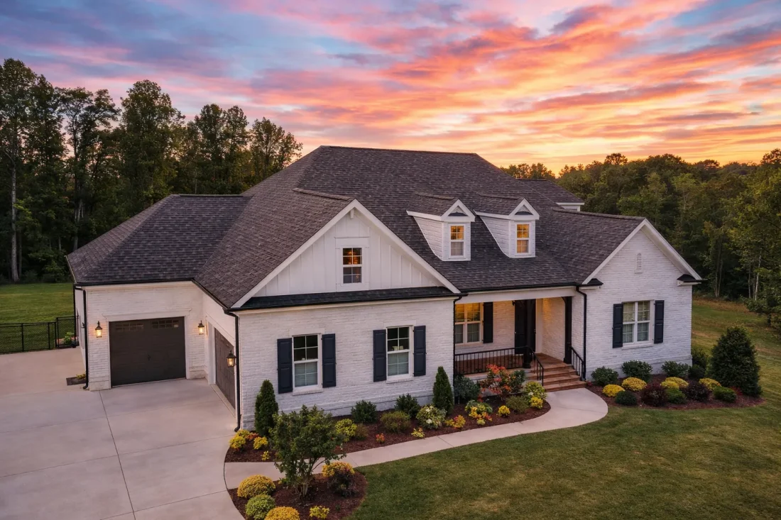 Front exterior view of a Traditional New American style home with symmetrical facade, gabled rooflines, lap siding, shutters, and covered entry porch