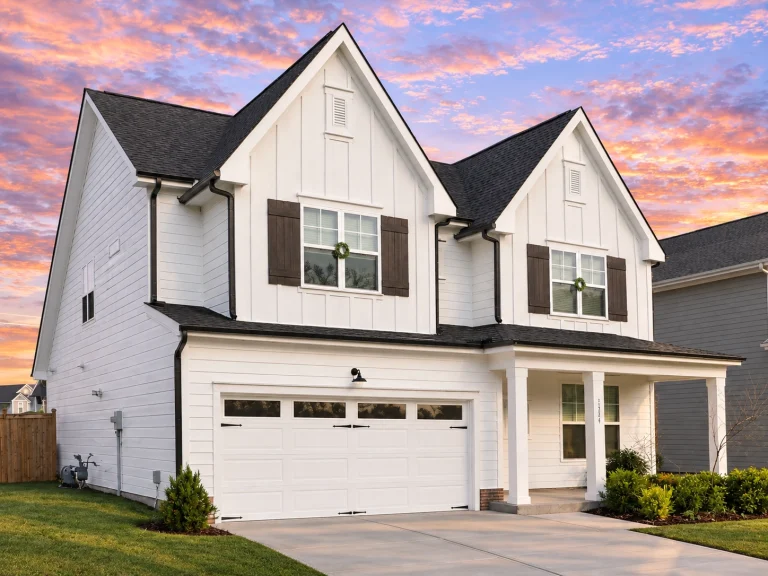 Garage Apartment Plans 13 Front elevation of a New American Traditional home with coastal Cape Cod influence, featuring shingle accents, lap siding, and a welcoming covered porch