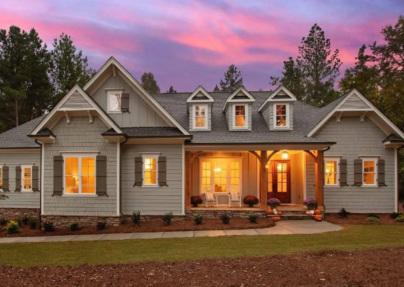Front exterior of a New American Modern Traditional house featuring Craftsman influences, gabled rooflines, horizontal siding, board and batten accents, and a welcoming covered porch